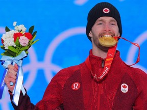 Canada's Max Parrot celebrates on the podium after winning gold in men's snowboard slopestyle at the Beijing Olympics, Feb. 7, 2022.