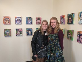 Veronica Funk (left) stands with daughter Katherine among some of the portraits painted as part of "The Grandmothers." 53 of 60 portraits are on display at the Leighton Art Centre, alongside stories about the women featured.