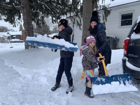 Parker Hotte, 10, his seven-year-old sister Savannah and their mom Tiffany of Brantford were busy clearing their sidewalk Friday after another night of snow. The children enjoyed a couple of snow days due to school closures on Thursday and Friday and the entire family, which includes dad Jonathan, are looking forward to skating at some neighbourhood rinks. VINCENT BALL