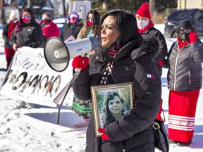 Chasity Martin holds a photograph of her aunt, Paula Joy Martin as she speaks at a MMIWGMB2S Valentines Memorial Walk on Monday February 14, 2022 in Ohsweken.