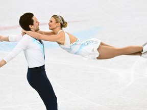Kirsten Moore-Towers and Michael Marinaro compete in the pair skating free skating of the figure skating event during the 2022 Winter Olympics in Beijing on Feb. 19. ANNE-CHRISTINE POUJOULAT/AFP via Getty Images