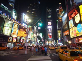Bright lights greet tourists N.Y.'s Times Square.