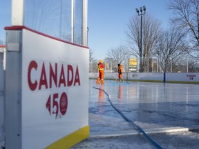 Gananoque Public Works department workers do maintenance on the Gord Brown Memorial/Canada 150 rink in January.