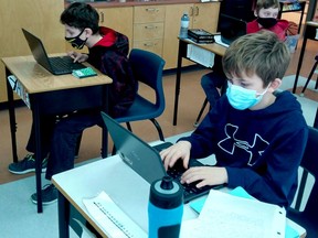 Students Xander, left, Erik and Mason, in back, from St. Mark Catholic School in Prescott, were three of more than 1,650 students from the CDSBEO to participate in Hour of Code last December. (SUBMITTED PHOTO)