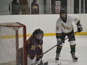 Athens goalie Kaleb Griffin and Westport forward William Burns eye the puck during the Aeros-Rideaus game on Tuesday night. Friday night's rematch in Westport has been postponed.
Tim Ruhnke/The Recorder and Times