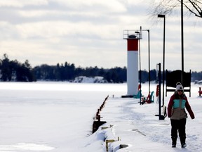 Anna Driedger bundles up for a walk along the windy St. Lawrence River at Blockhouse Island on Friday afternoon. (RONALD ZAJAC/The Recorder and Times)