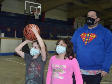 Juliette Lemery lines up a shot at a Brockville Blazers basketball net while sister Alice and dad Tyler look on inside the Leo Boivin Community Centre in Prescott on Family Day 2022.
Tim Ruhnke/The Recorder and Times