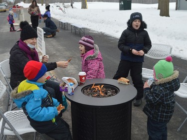 Enjoying fireside refreshments on Dibble Street East as part of Prescott's Family Fun Day on Monday afternoon were (from left) mom Holly Patenaude and Phillip, Jillian, William and Millie.
Tim Ruhnke/The Recorder and Times
