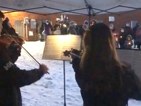 Handout Davis and Keri Wood play the violin during the first Affirmation of Hope candlelight ceremony, held Monday night to honor the lives of homeless people who have died.  The event was organized by Chatham Hope Haven.