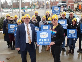 Chatham-Kent Mayor Darrin Canniff, left, received his Coldest Night of the Year toque from Al Baker, network co-ordinator of NeighbourLink, for the upcoming fundraiser on Saturday, Feb. 26. Also pictured is a large contingent of people who will be participating in the fundraiser. PHOTO Ellwood Shreve/Chatham Daily News