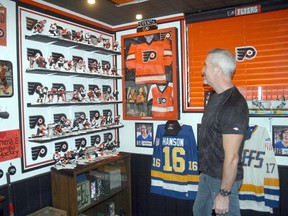 Exeter's Larry Mathers with part of his Philadelphia Flyers shrine which recently won him the 'Man Cave of the Year' award from mancavesite.org. Scott Nixon
