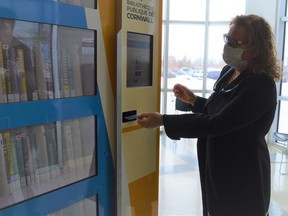 CEO and chief librarian Helen McCutcheon demonstrating how to scan a library card, or cellphone, to access the NovelBranch kiosk at the Benson Centre on Thursday February 10, 2022 in Cornwall, Ont. Shawna O'Neill/Cornwall Standard-Freeholder/Postmedia Network