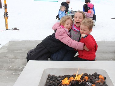Enjoying the fire pit area at Big Ben Ski Centre on Monday afternoon are the Demerchant kids, from left, Evie, Lyla and Miller. Photo on Monday, February 21, 2022, in Cornwall, Ontario.Todd Hambleton/Standard-Freeholder/Postmedia Network