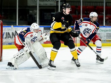 Cornwall Colts goaltender Emile Savoie peeks around a screening Smiths Falls Bears Riley Thompson during play on Thursday February 24, 2022 in Cornwall, Ont. The Colts lost 6-3. Robert Lefebvre/Special to the Cornwall Standard-Freeholder/Postmedia Network