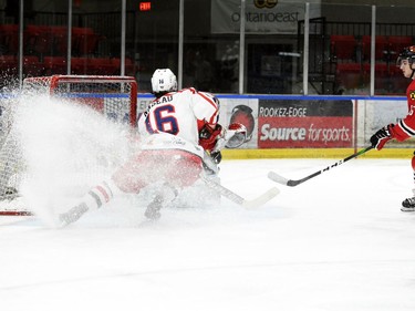 Cornwall Colts Emerick Nadeau throws up snow as Brockville Braves goaltender Sami Molu smothers the puck during play on Thursday February 3, 2022 in Cornwall, Ont. The Colts lost 5-2. Robert Lefebvre/Special to the Cornwall Standard-Freeholder/Postmedia Network