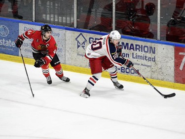 Cornwall Colts Tristan Miron skates up the boards with the puck, followed by Brockville Braves Thomas Haynes during play on Thursday February 3, 2022 in Cornwall, Ont. The Colts lost 5-2. Robert Lefebvre/Special to the Cornwall Standard-Freeholder/Postmedia Network