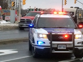 Cornwall Police Service was at Brookdale Avenue and Water Street on Saturday, February 12, 2022, in Cornwall, Ont., helping manage traffic after tractors slowed down access to the bridge. Todd Hambleton/Cornwall Standard-Freeholder/Postmedia Network