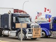 Anti-mandate demonstrators gather as a truck convoy blocks Hwy 4 at the busy U.S. border crossing in Coutts, Alta., on Monday, Jan. 31, 2022.