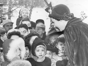 Royal Tour of Canada -- October 19, 1951: Ronald Anderson, 2 1/2-year-old son of Mr. and Mrs. Arthur Anderson of Springbank, was well bundled up in his blue, fur-trimmed snowsuit, and that is what caught Princess Elizabeth's (now Queen Elizabeth II) eye as she and the Duke of Edinburgh made a 10 minute stop at Cochrane Thursday afternoon. She stopped to tell Ronald (left foreground) that he looked well bundled up for the weather, when his sister, Linda, four, standing behind her brother in a similar outfit, asked the Princess how Prince Charles was. Photo: Calgary Herald file photo (from Herald negative collection held at the Glenbow Museum)
*Calgary Herald Merlin Archive*
