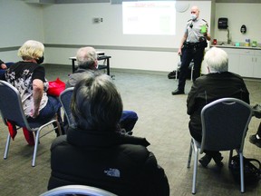 Sgt. Chris Mosley discussed ways to prevent fraud, including calling the RCMP to check on potential scams, during a town hall meeting last Saturday. (Ted Murphy)