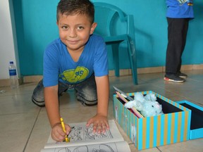 Children in El Salvador checking out their Canadian-packed Operation Christmas Child shoeboxes.