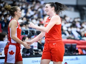 Canada's Bridget Carleton, right, celebrates during a game against Japan at a FIBA Women's Basketball World Cup qualifying tournament in Osaka, Japan, on Thursday, Feb. 10, 2022. (Photo courtesy of FIBA)