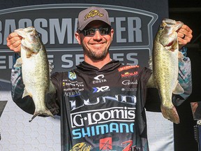 Jeff Gustafson holds up a pair of bass he brought to the scales this past weekend at the Harris Chain of Lakes in Florida.