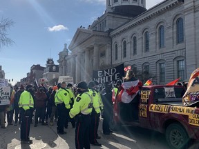 Counter-demonstrators block Ontario Street to pro "Freedom Convoy" protesters participating in the "downtown slow roll" on Saturday in Kingston.