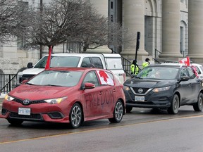 Slow-roll 'Freedom Convoy' travelling through Kingston 4 “Freedom Convoy” participants drive past City Hall in Kingston on Monday.