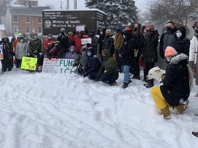 Protesters gather outside the Kingston offices of the Ontario Ministry of Health on Feb. 25, 2022, as part of a rally calling for provincial funding for the Integrated Care Hub in Kingston.