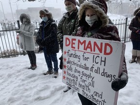 A protester holds a sign outside the Kingston offices of the provincial Ministry of Health on Friday, Feb. 25, as part of a rally calling for provincial funding for the Integrated Care Hub. Brigid Goulem/The Kingston Whig-Standard/Postmedia Network