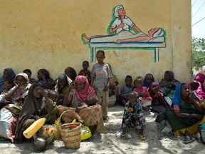 In this file photo taken in February 2012, internally displaced Somalis wait for food aid rations near a distribution centre in war-torn capital, Mogadishu. Currently, an estimated 13 million people in Kenya, Somalia and Ethiopia are facing severe hunger as the Horn of Africa experiences its worst drought in decades, the World Food Program said Tuesday.