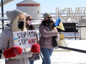 Anna Deriushea, left, attends an event at noon on Monday, Feb. 29, 2022, in Confederation Park across from Kingston City Hall to show local support for the people of Ukraine as they endure the Russian invasion. The event was organized by the Kingston Interfaith Community group.