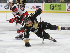Kingston Frontenacs forward Paul Hughes falls after getting past Ottawa 67's Alex Johnston in Ontario Hockey League action at the Leon's Centre in Kingston on Family Day Monday.