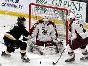 Kingston Frontenacs forward Jackson Stewart and Peterborough Petes defenceman Samuel Mayer eye the puck in front of Peterborough goaltender Tye Austin in Ontario Hockey League action at the Leon's Centre on Wednesday.