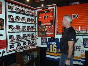 Exeter's Larry Mathers with part of his Philadelphia Flyers shrine which recently won him the 'Man Cave of the Year' award from mancavesite.org.