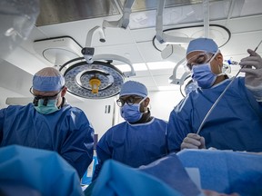 Dr. Wael Abuzeid, right, and other staff at Kingston Health Sciences Centre perform the minimally invasive mitral valve clip repair.