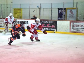 Photo by KEVIN McSHEFFREY/THE STANDARD
Elliot Lake Red Wings Owen Ciavoliello and Hearst Lumberjacks player race for the puck during Saturday’s game at the Centennial Arena. For the storey, see page 6.