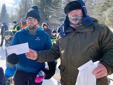 Barry Kidney caught the third largest fish during the third annual Laurentian Valley Ice Fishing Derby, held Feb. 12 on Lemke Lake. He accepted his prize from Rick Klatt (right), volunteer co-ordination of the derby.