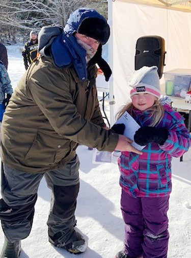 Molly Coulas caught the fifth largest fish during the third annual Laurentian Valley Ice Fishing Derby, held Feb. 12 on Lemke Lake. She accepted her prize from Rick Klatt (right), volunteer co-ordination of the derby.