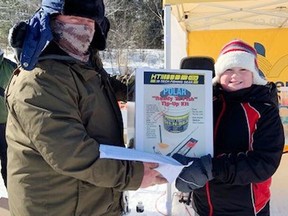 Rick Klatt, volunteer co-ordination of the Laurentian Valley Ice Fishing Derby, presented Hudson Coulas with the top prize after he caught the longest fish in the derby, which was held on Lemke Lake on Feb. 12. Submitted photo