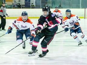 Nate Headrick (middle) of the Blind River Beavers, in recent NOJHL action against the Soo Thunderbirds. SAULT THIS WEEK