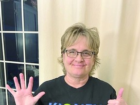 Marci Oliverio illustrates the six-finger salute of the fourth annual #SixDegreeChallenge.