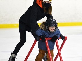 Brook Flowers aids nephew Kip Thompson around the rink during his first-ever visit to Parents & Tots program offered at the West Perth Arena in Mitchell Dec. 17. ANDY BADER/MITCHELL ADVOCATE