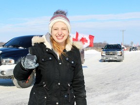 Erin Barry from Wyoming gives the thumbs up as a convoy protesting COVID-19 mandates leaves a truck stop and heads towards Highway 402 on Sunday, Feb. 6, 2022 in Plympton-Wyoming, Ont. Terry Bridge/Sarnia Observer/Postmedia Network
