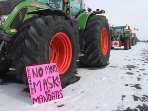 Farm vehicles are shown parked Sunday along a section of westbound Highway 402.