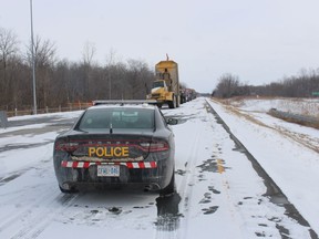 A quarry truck and several farm vehicles are shown in this Postmedia file photo parked along a section of westbound Highway 402 on Feb.  13, 2022. (PAUL MORDEN/Postmedia Network)
