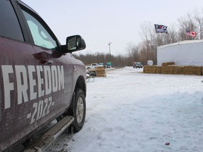 A campsite and gathering spot is shown next to a “Freedom Convoy” demonstration that has led to the shutdown of a section of the westbound lanes of Highway 402.