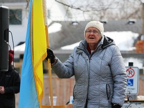A woman holds a Ukrainian flag during a vigil for the country amid the Russian invasion at St. George's Ukrainian Catholic church on Sunday, Feb. 27, 2022, in Sarnia, Ont. Terry Bridge/Sarnia Observer/Postmedia Network