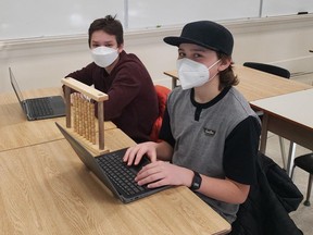Acton Riddoch, left, and Eli Senko mix ancient learning tool with the new. A Grade 9 math class at Waterford District High School has transitioned to paperless learning. The new format has been shown to provide many benefits for both the teacher and students. CONTRIBUTED PHOTO